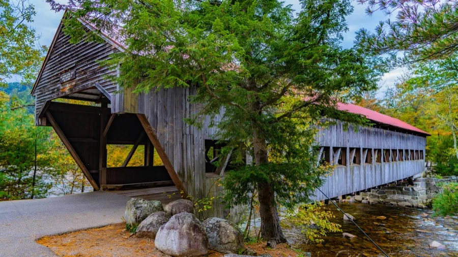 Historic wooden Albany Covered Bridge spanning the Swift River along the Kancamagus Highway in New Hampshire